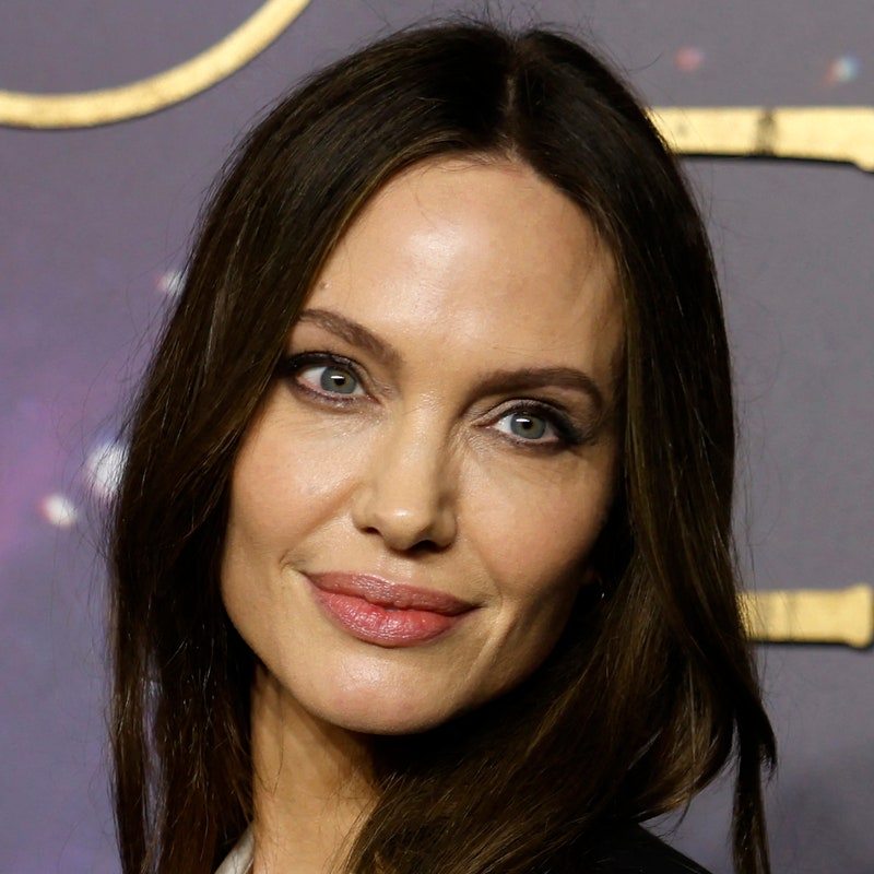 angelina jolie with slightly curled hair smiling 