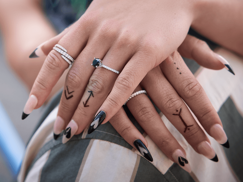 A woman poses, adorned with beautiful Diamond Rings.