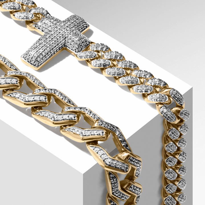 A diamond cross necklace elegantly draped on a gold chain, showcasing a blend of luxury and faith.