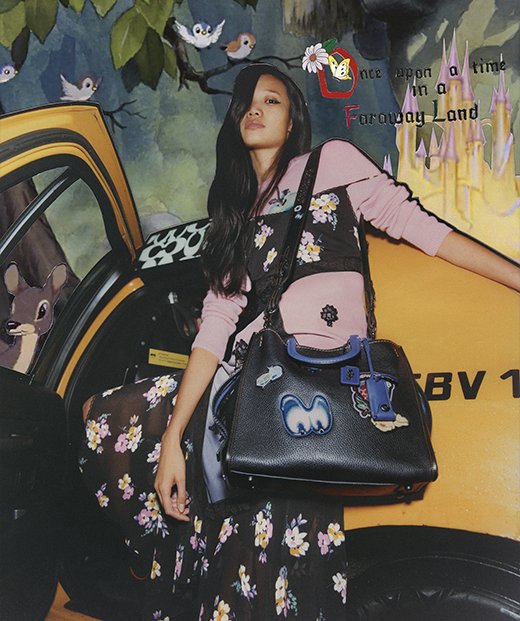 Model with Coach Rogue Bag with Patches