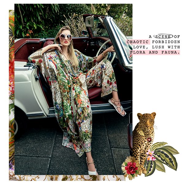 Model in green and floral printed jumpsuit and layer in car.