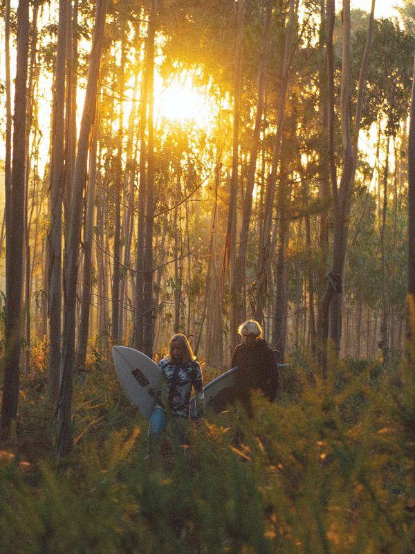 Melodie and Harry walk through the brisk Portugal forest