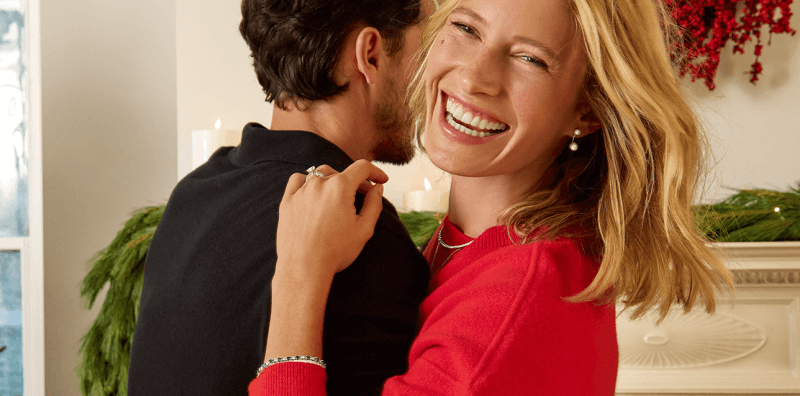 A couple dancing, showcasing a variety of stunning Necklaces, Rings