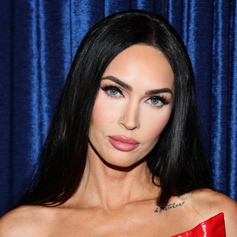 Megan Fox appears at an event in a red strapless latex dress.