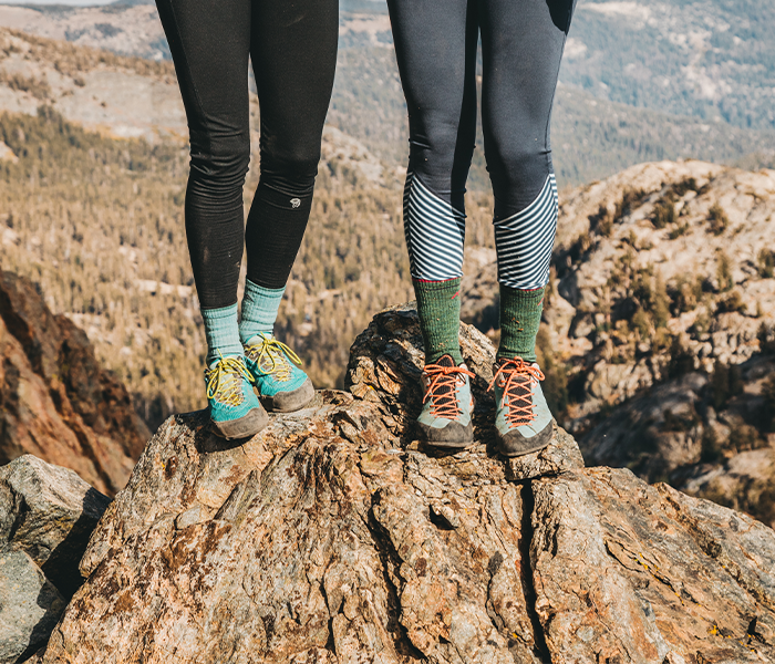 Two hikers stand above a rocky mountain top - very happy feet*feat.