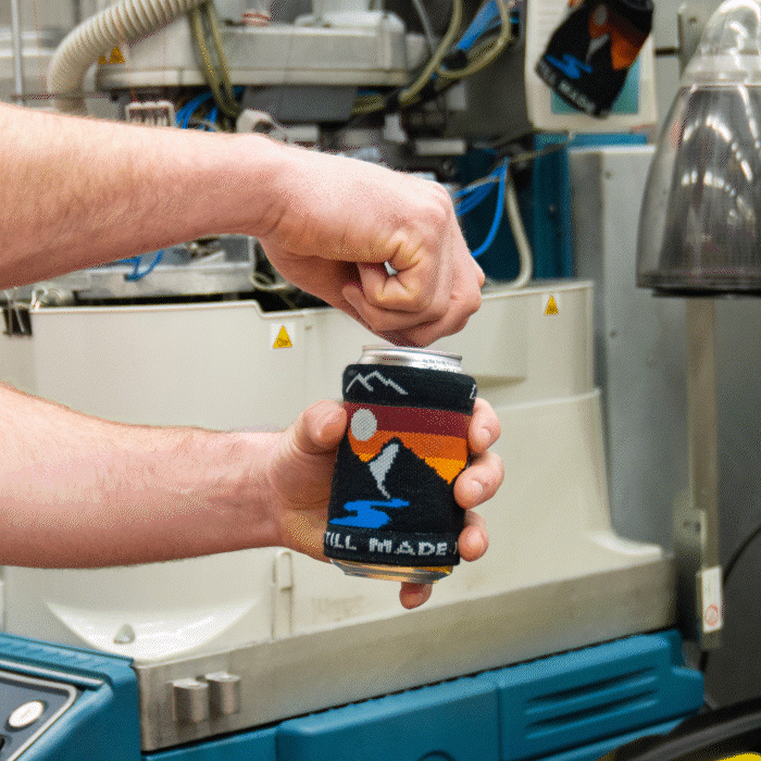 Cracking open a drink. That drink looks mighty fine in it's Darn Tough drink koozie, with a mountain design