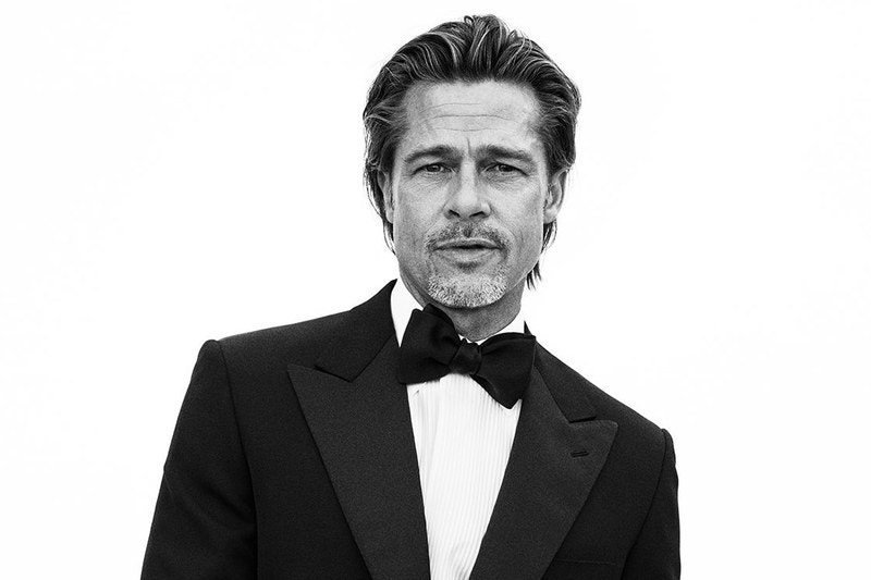 Image may contain: Brad Pitt, Clothing, Apparel, Overcoat, Coat, Suit, Tuxedo, Accessories, Tie, Accessory, Human, and Person