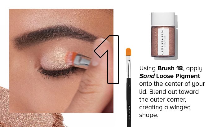 1. Using Brush 18, apply Sand Loose Pigment onto the center of your lid. Blend out toward the outer corner, creating a winged shape.