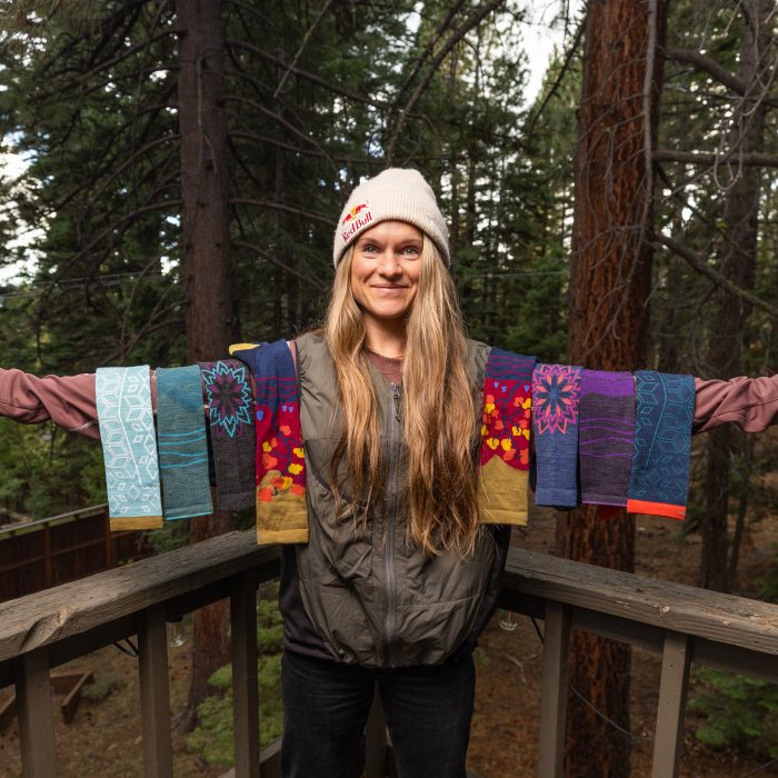 Read the blog - pro skier Michelle Parker displays 7 colorful snow socks on her outstretched arms