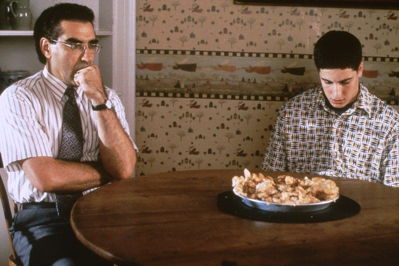 film still from american pie of dad and son looking at pie on table