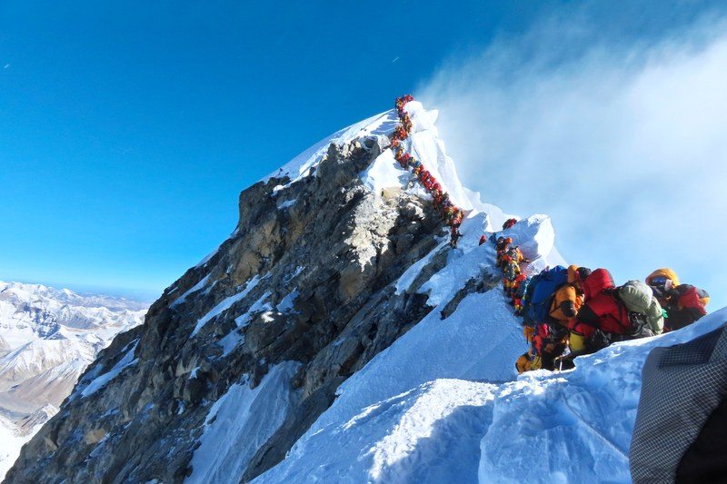 This image may contain Nature, Mountain, Peak, Outdoors, Mountain Range, Human, Person, Snow, Ice, Sport, and Sports