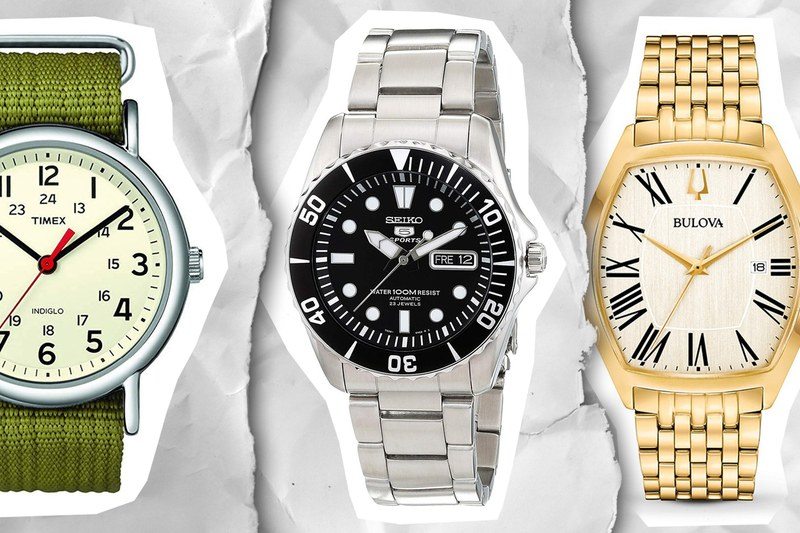 A green and silver watch, a silver and black watch, and a gold and white watch on a white ripped up paper background