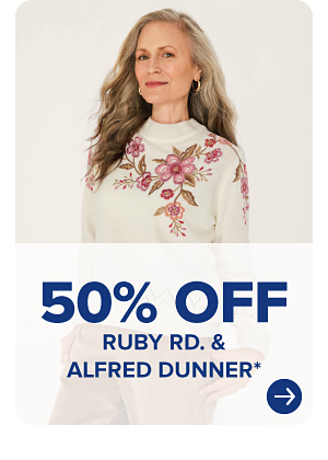 A woman in a white sweater with pink flowers on it. 50% off Ruby Road and Alfred Dunner.