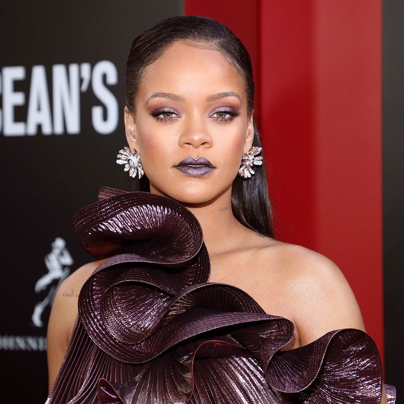 Rihanna pairs purple eyeshadow with a purple lip.