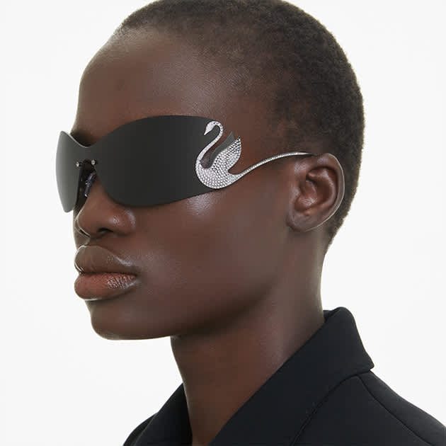 Model wearing sunglasses with swan silhouette