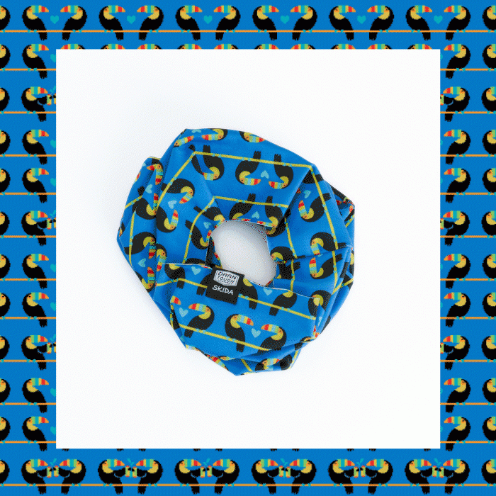 A Skida neck gaiter with the Toucan design from our Toco Loco socks