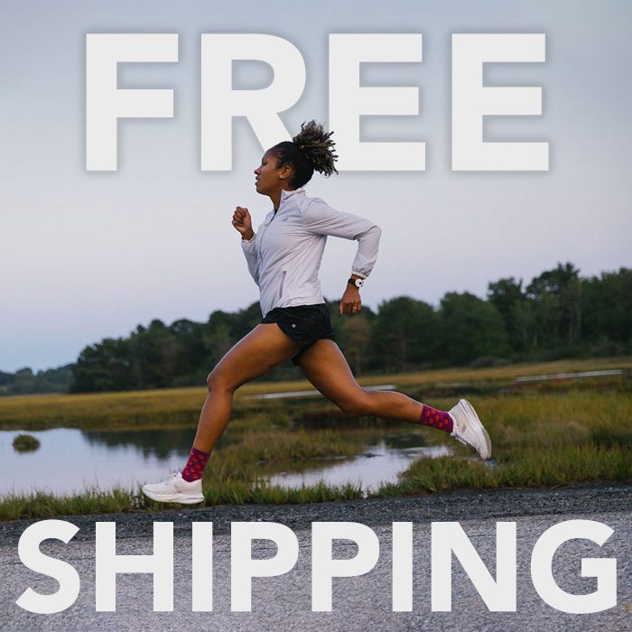 Free Shipping message over image of a runner going full - sprint wearing pink polka dot running socks