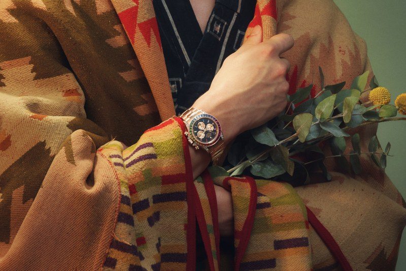 Model wearing a Rolex Cosmograph Daytona “Rainbow”