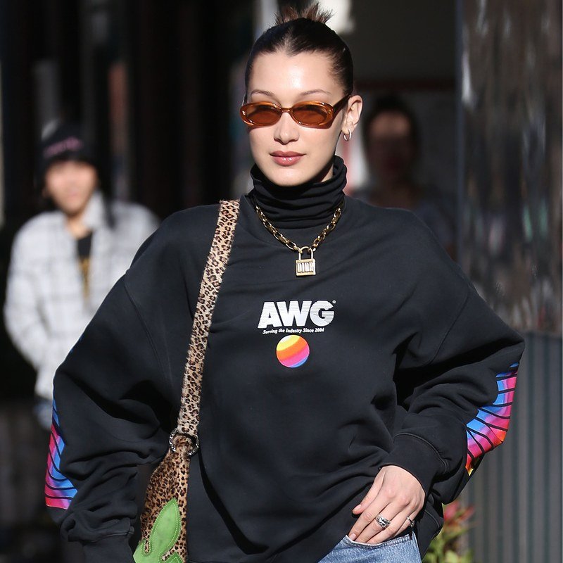 Bella Hadid pairs a slick dark knot with oblong sunglasses.