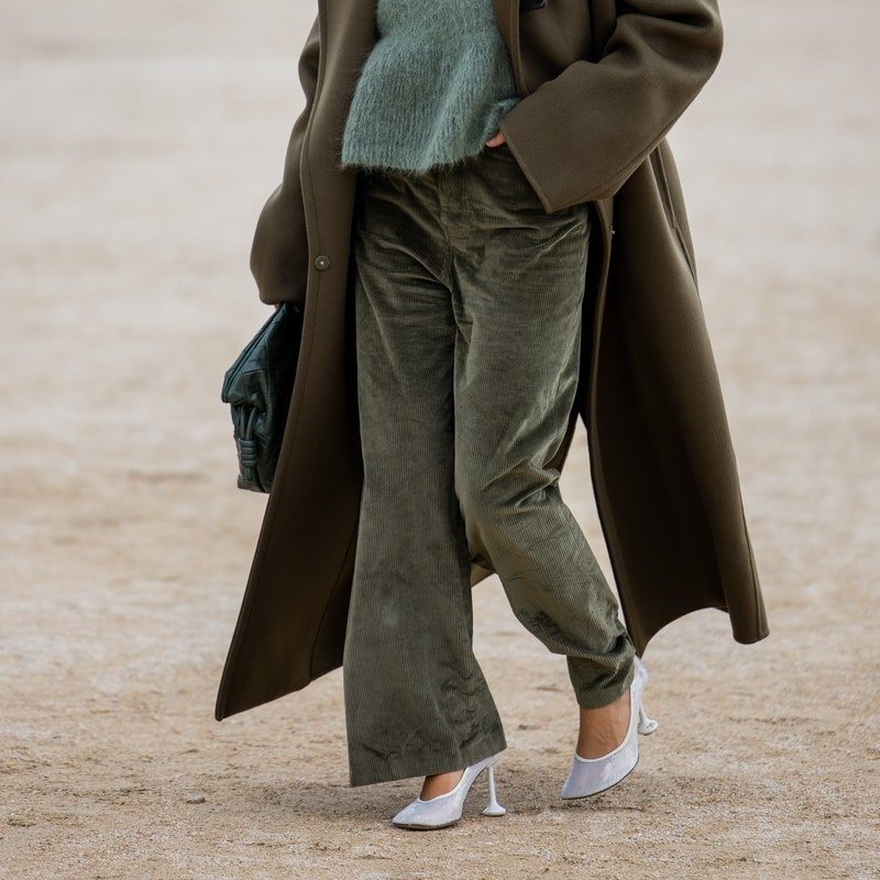 a woman in corduroy trousers