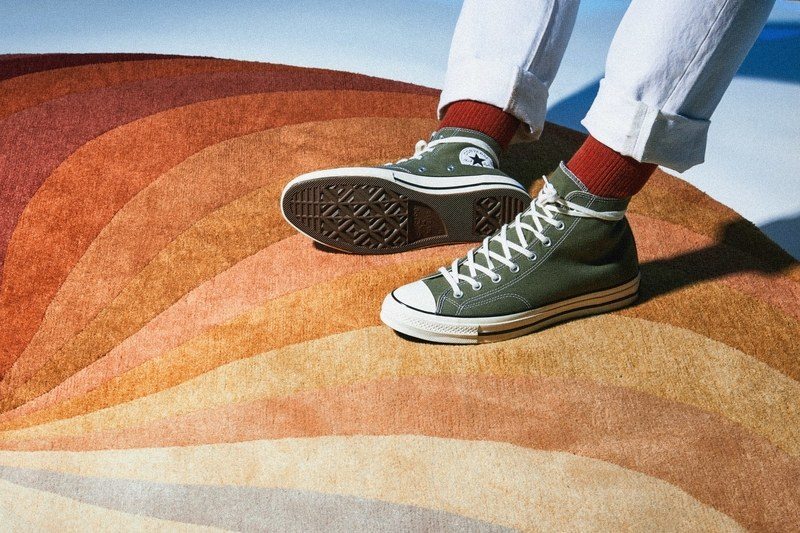 This image may contain Footwear, Clothing, Apparel, Shoe, Soil, Human, Person, Rug, Sock, Sand, Outdoors, and Nature