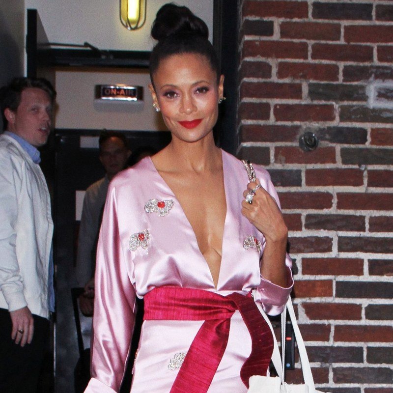 Thandie Newton pairs a topknot with a red lip.