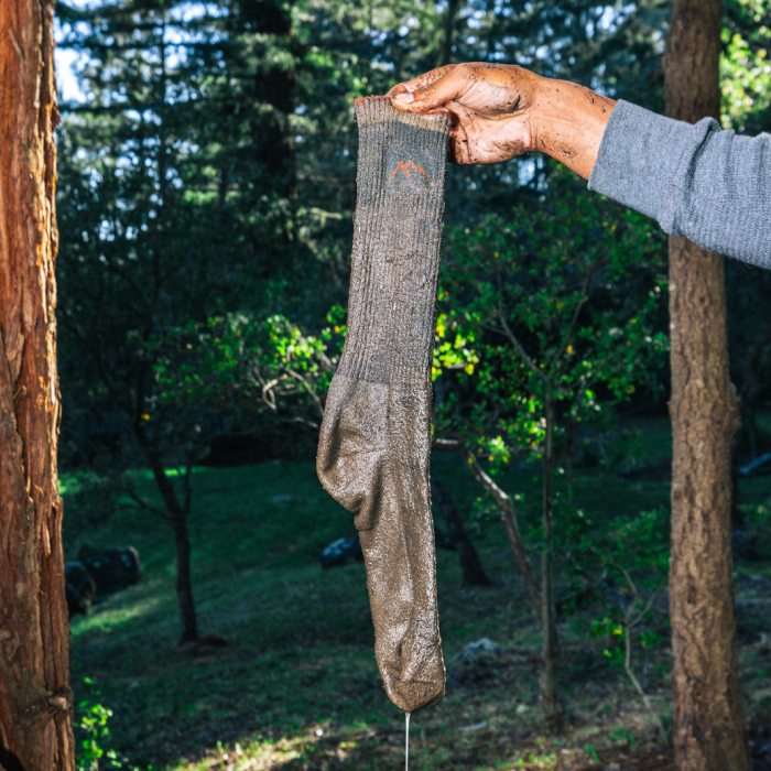 More about Merino - a water-logged Darn Tough hiking sock drips with mud